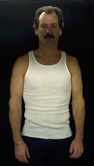 Barry Newton, the Bearmonster, standing with hands at his sides, looking forward.